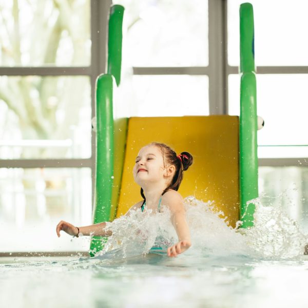 Little girl sliding down the water slide